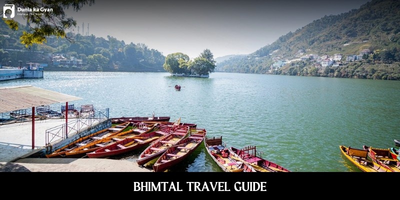 Bhimtal Lake with boats, hills, and island in the center