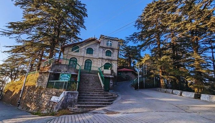 Landour Mussoorie view with colonial-era building, stone steps, and deodar trees