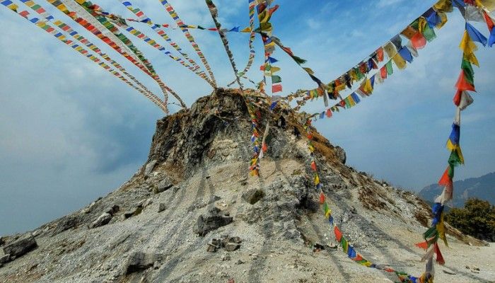 Colorful flags at George Everest Peak in Mussoorie with panoramic Himalayan views