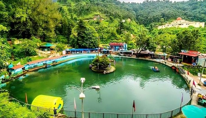 Mussoorie Lake surrounded by lush green hills with boating facilities