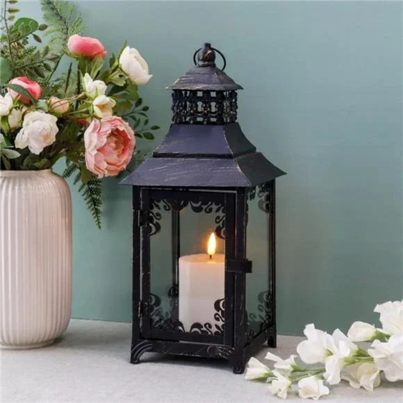 Vintage style candle lantern with classic metal design, creating a warm and cozy ambiance