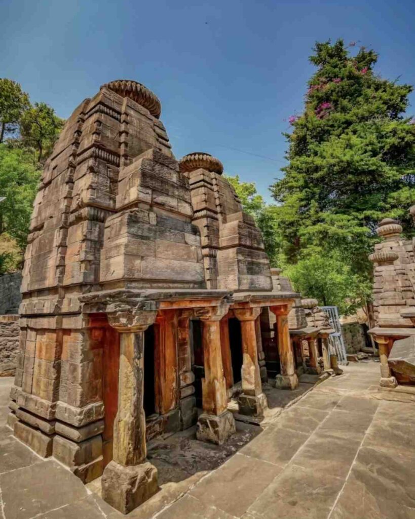 Ancient Katarmal Sun Temple near Almora featuring stone architecture and mountain backdrop.