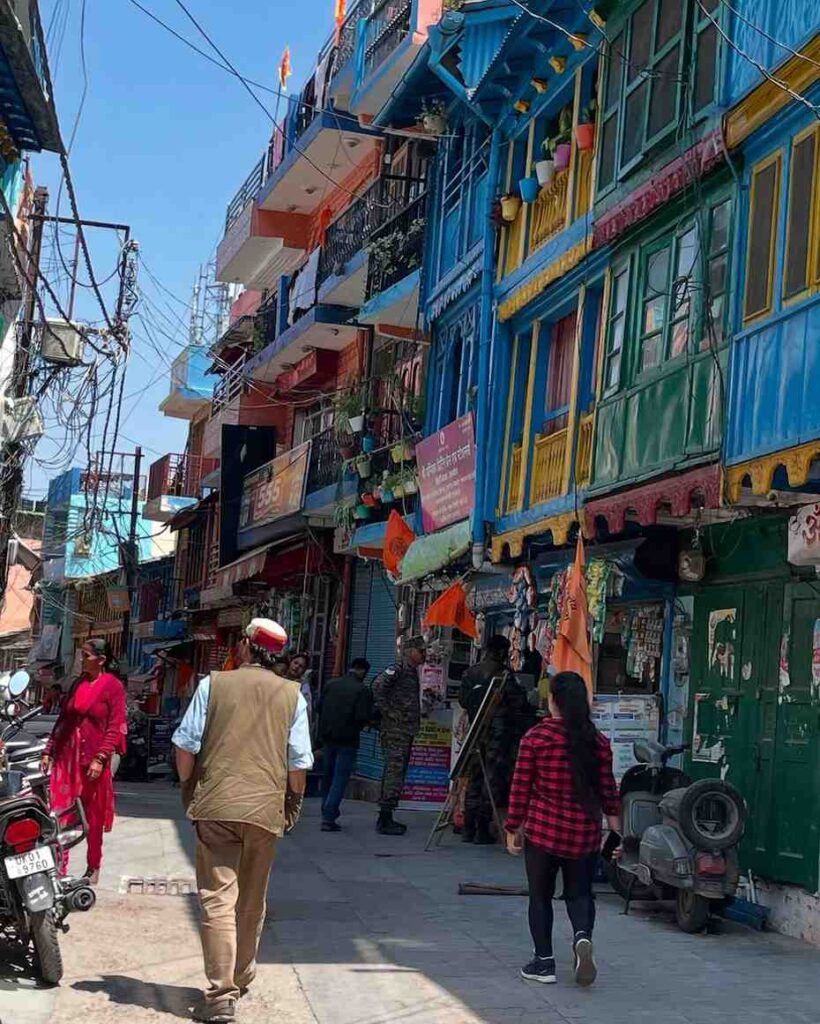 Colorful shops and busy street at Lala Bazaar in Almora with locals shopping for traditional goods.