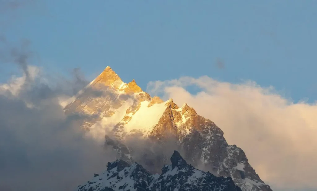 Sunrise over Trishul and Nanda Ghunti peaks as seen from Gwaldam, Uttarakhand.